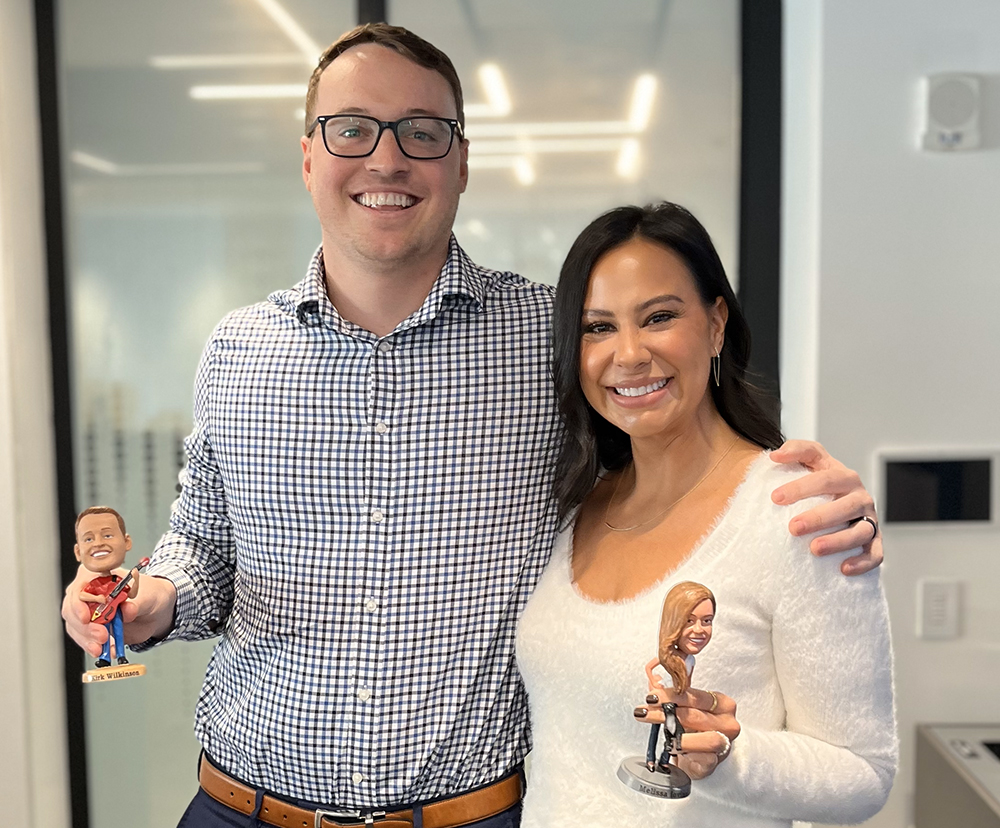 employees receive custom bobble heads for their 5 year anniversaries